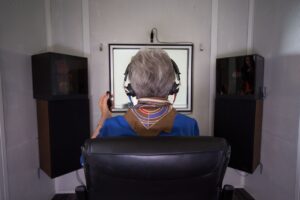 hearing assessment in Toronto with a patient completing a hearing test in a sound booth.