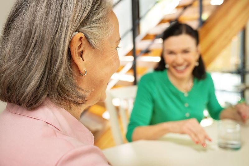 person with mild hearing loss wearing a hearing aid
