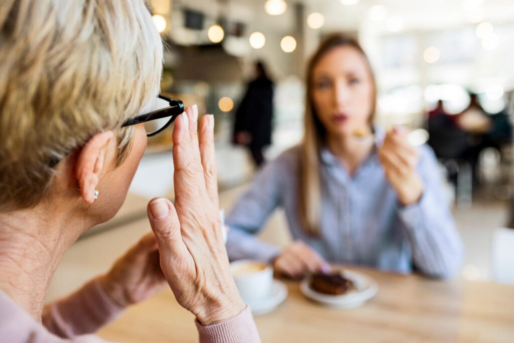 older adult with hearing loss and cognitive health in a conversation